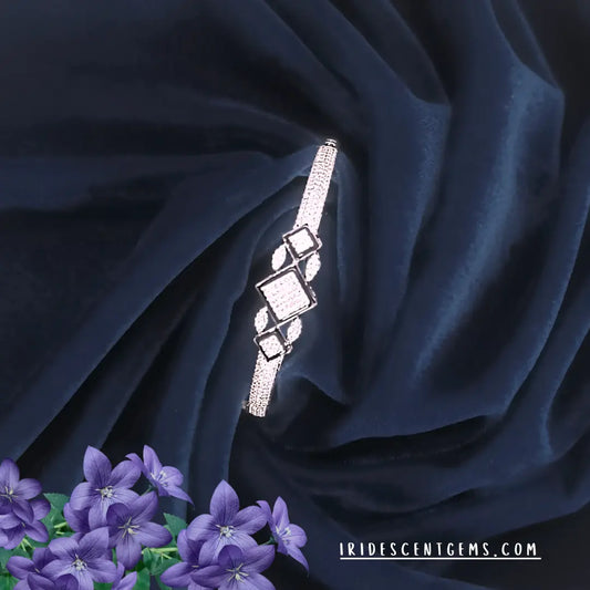 Geometric American Diamond Bracelet on dark blue fabric with purple flowers, brand 'Iridescent Gems' 