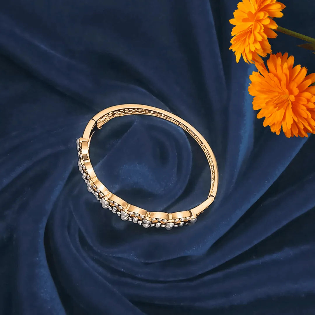 jadau bracelet for women  on a blue fabric background with orange flowers
