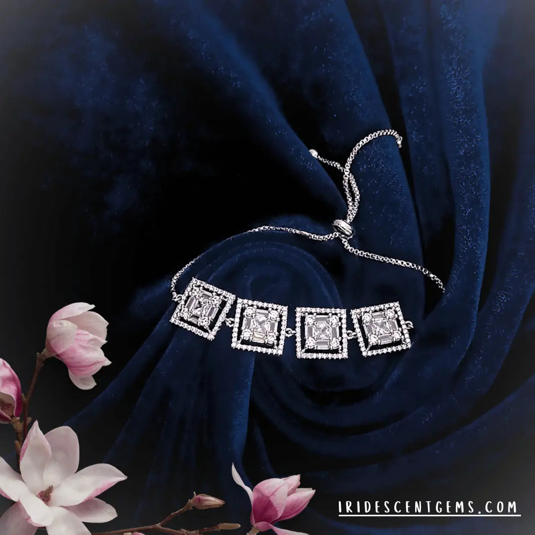Adjustable rhodium finish American diamond bracelet with square-cut stones on blue velvet