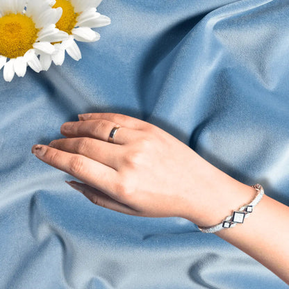 Close-up American diamond bracelet on blue background, geometric design