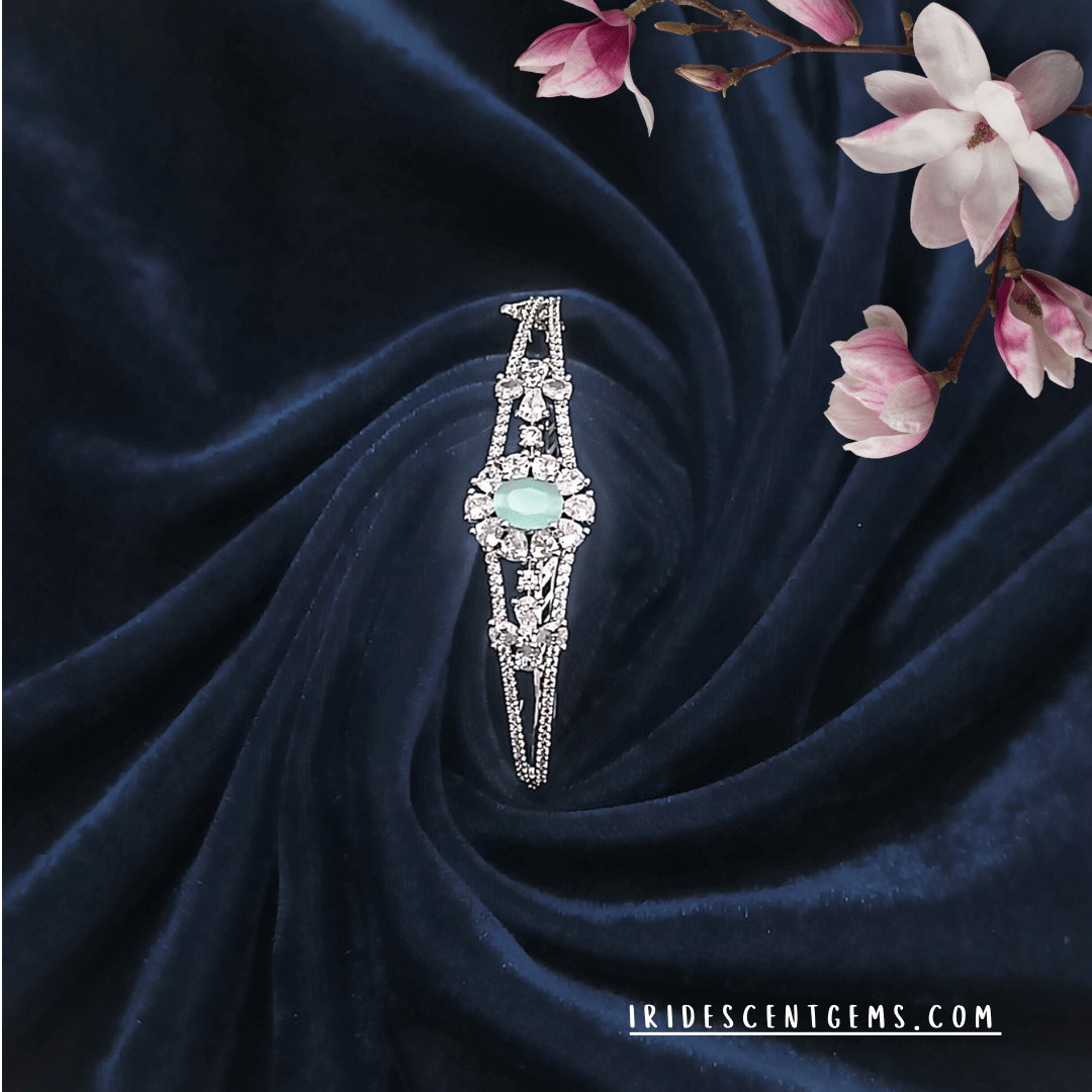 A delicate silver bracelet featuring a radiant blue gemstone, designed for timeless beauty and grace.