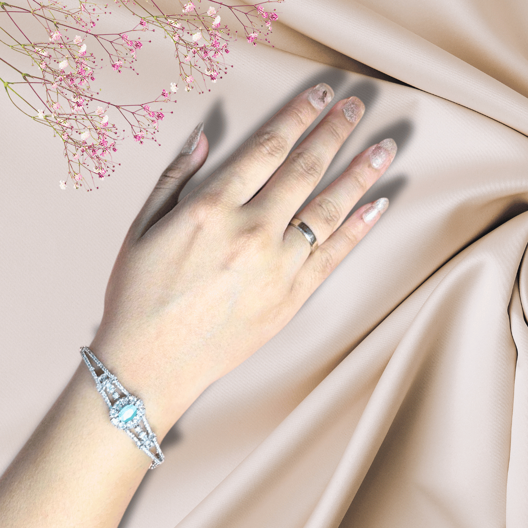 A stunning silver bracelet adorned with a shimmering aquamarine gemstone, exuding elegance and sophistication.
