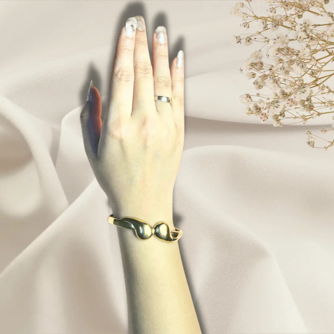 Gold bangle bracelet for women close up, fixed size fit on hand