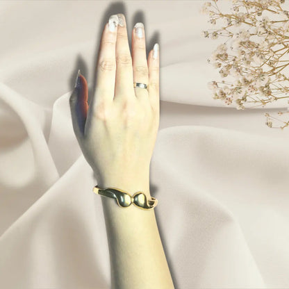 Gold bangle bracelet for women close up, fixed size fit on hand