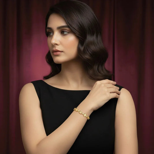 Gold bangle bracelet for women worn by model in elegant black dress