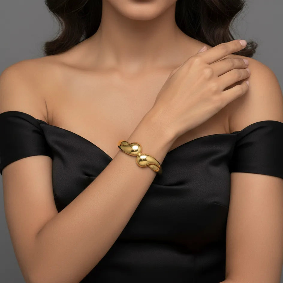  Gold bangle bracelet for women worn by model, minimalist jewelry style