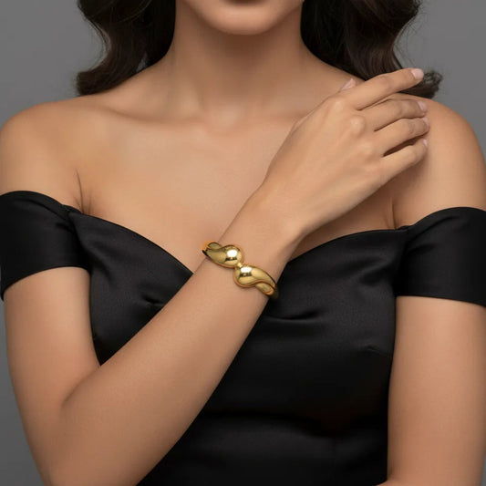  Gold bangle bracelet for women worn by model, minimalist jewelry style
