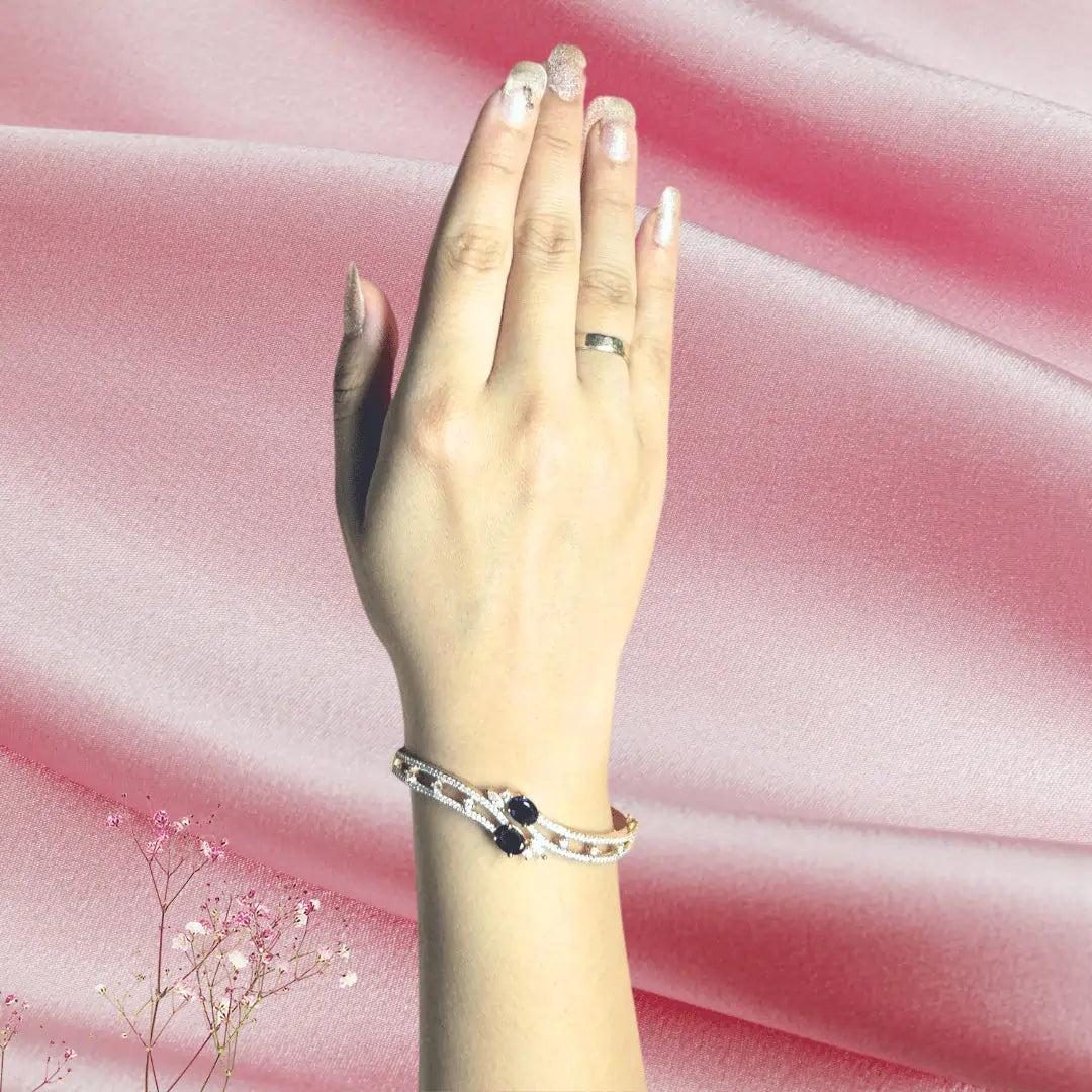 Gold plated American diamond bracelet with clip closure shown on wrist in natural daylight