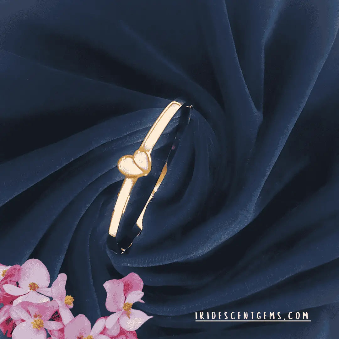  Gold plated bracelet for women with heart detail on navy fabric background