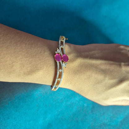 Pink stone gold plated American diamond bracelet on pink satin fabric background, elegant jewelry