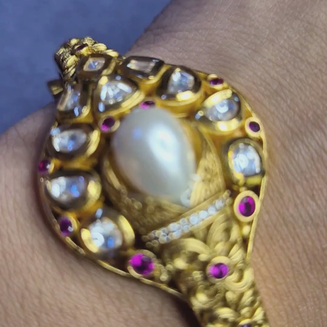 Kundan bracelet traditional gold with pearl and ruby accent, shown in detailed video view