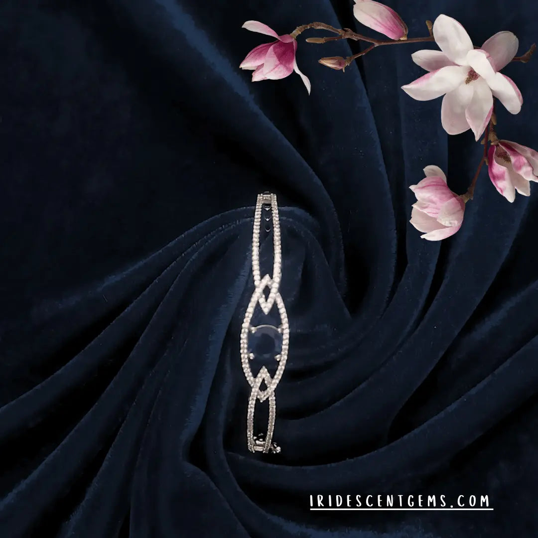 Radiant rhodium plated American diamond bracelet on blue velvet background