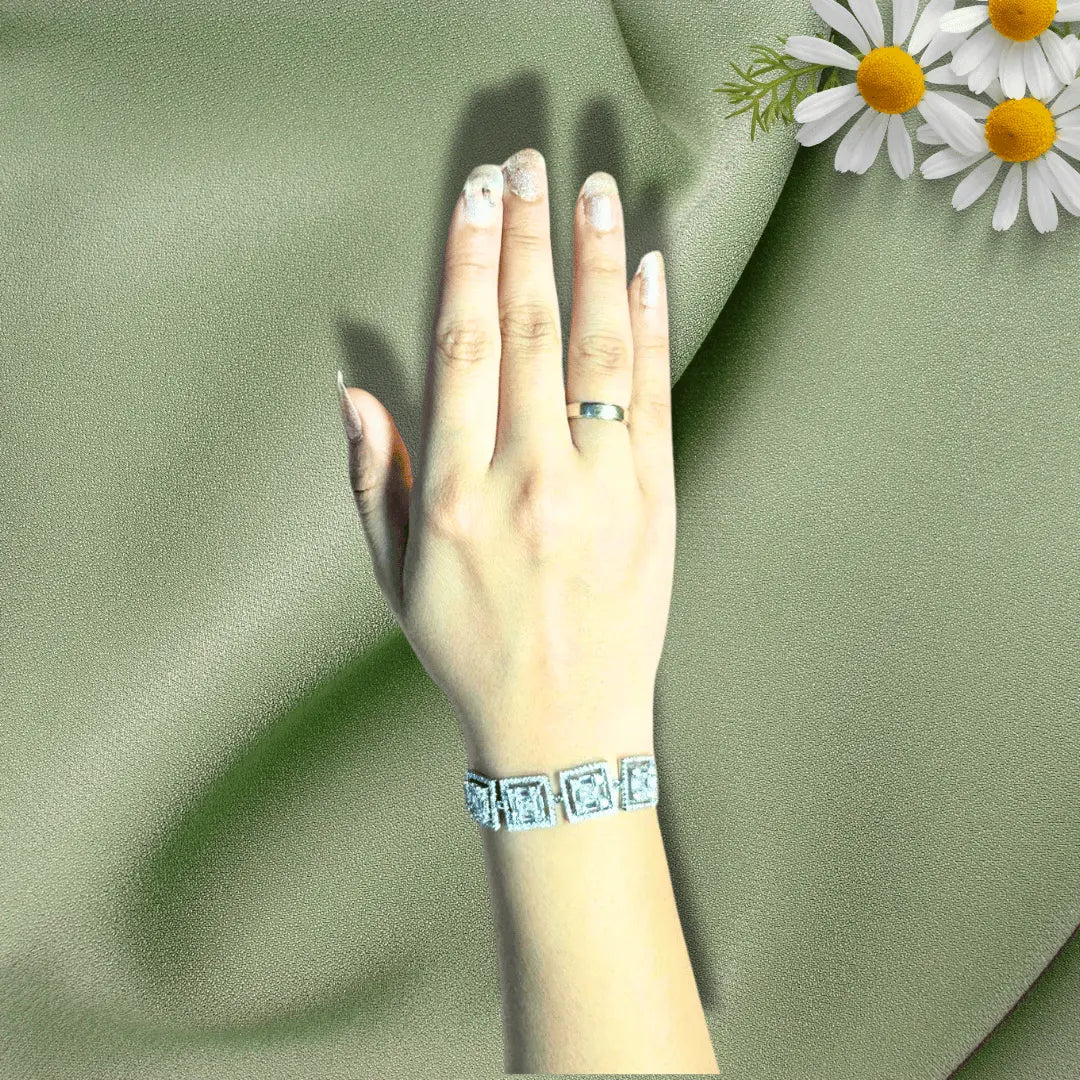 Square cut diamond adjustable bracelet on hand with floral accent