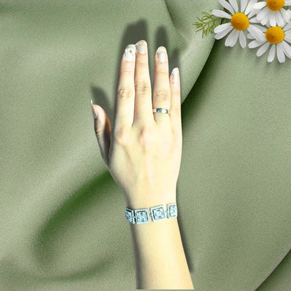 Square cut diamond adjustable bracelet on hand with floral accent